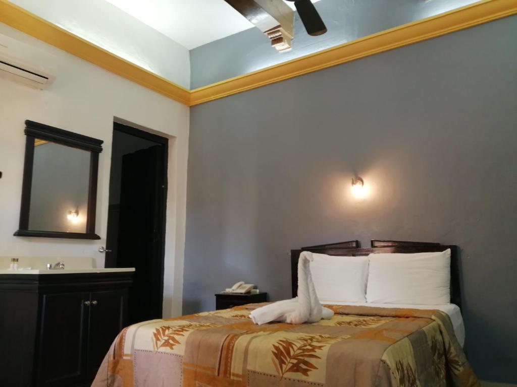 Postel nebo postele na pokoji v ubytování Hotel Montejo