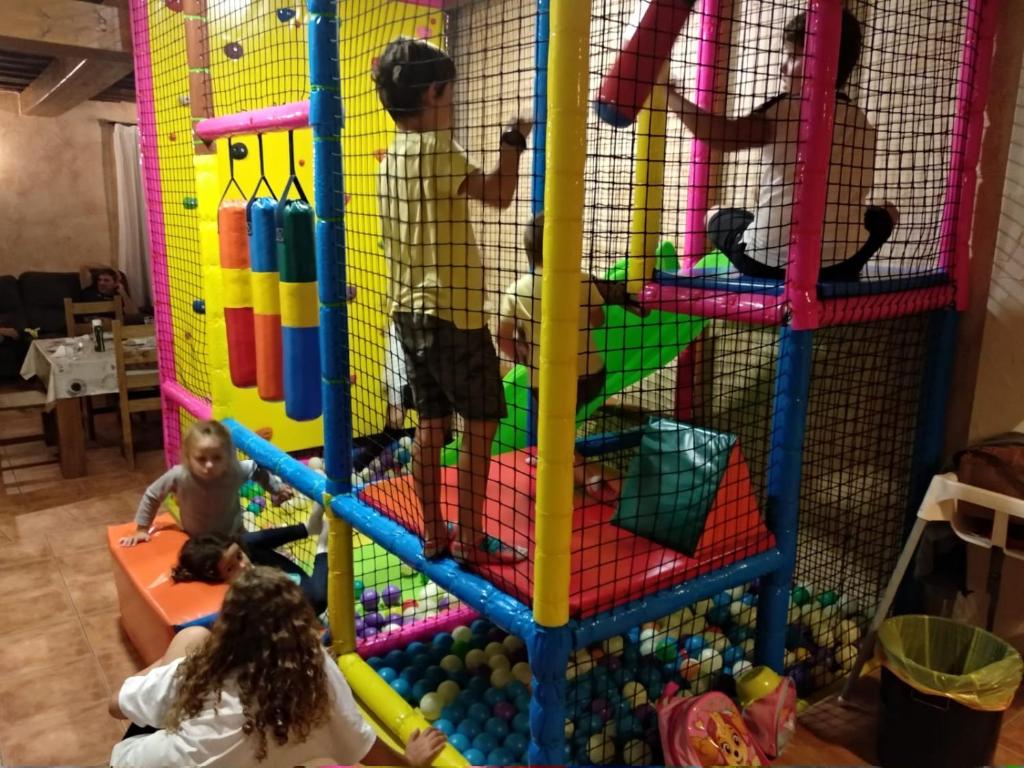 dos niños jugando en una sala de juegos con en Casa Rural Tio Mora en Horche