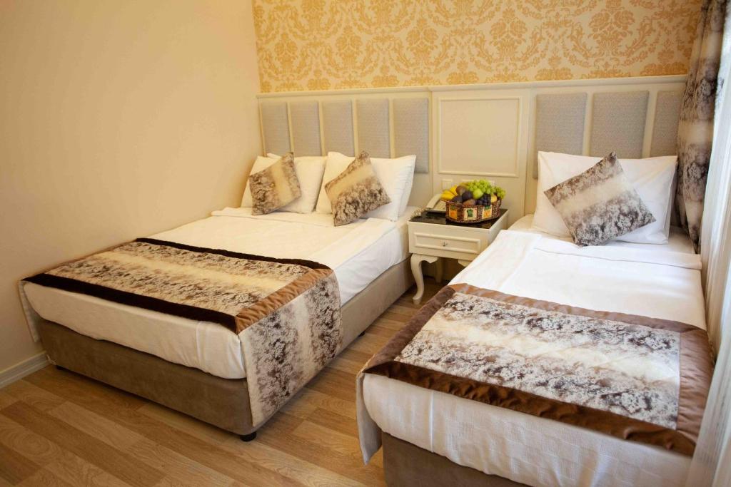 Postel nebo postele na pokoji v ubytování Best Nobel Hotel