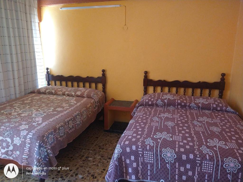 Letto o letti in una camera di Hotel Olimar