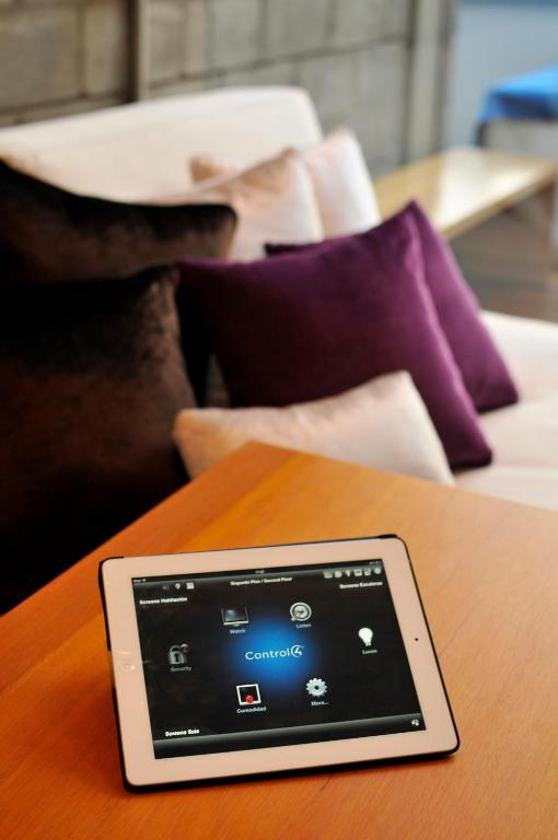 a tablet sitting on a table next to a bed at AcquaSanta Lofts Hotel in Cali