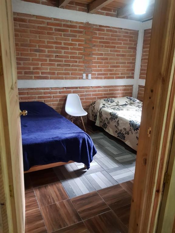 Postel nebo postele na pokoji v ubytování Cabañas las Alazanas