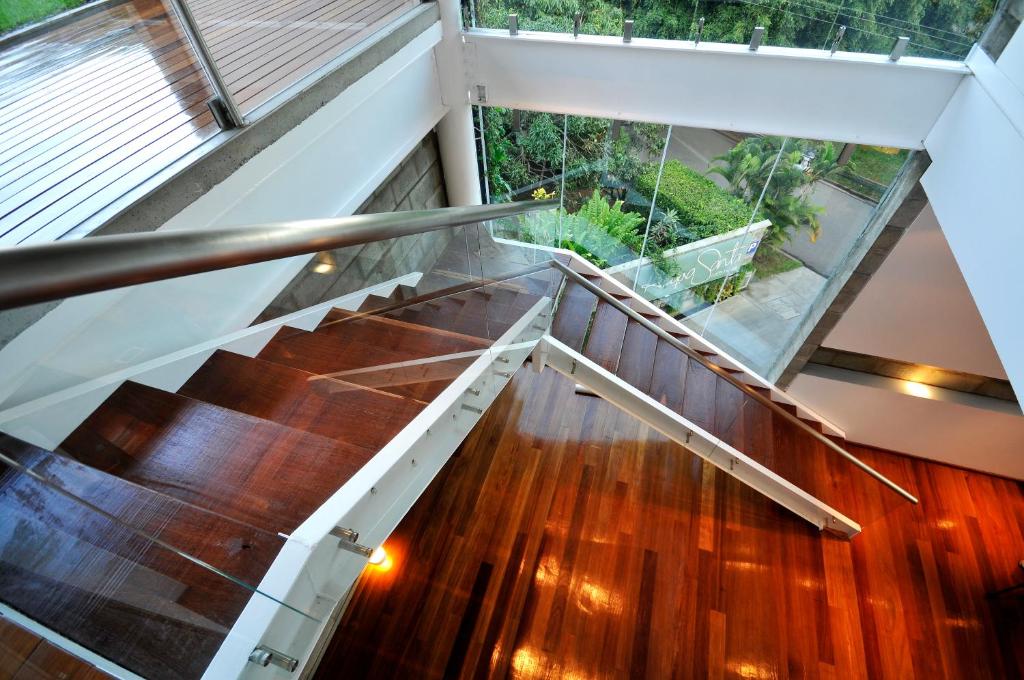 a staircase in a house with wooden floors and a glass ceiling at AcquaSanta Lofts Hotel in Cali
