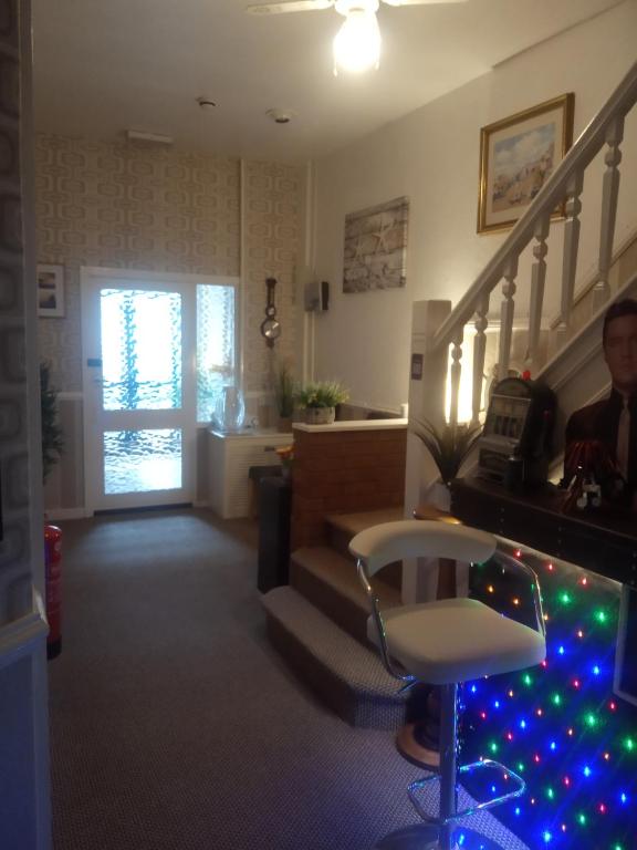 a living room with a staircase with christmas lights at THE ROCK n ROLL in Blackpool