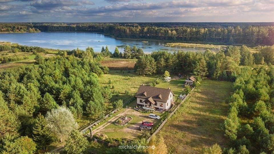 an aerial view of a house and a lake at Galikowo in Płaska