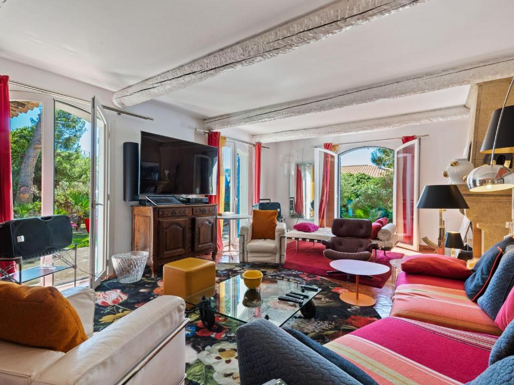 a living room with a couch and a tv at Scenic villa in Martigues with private pool in La Couronne