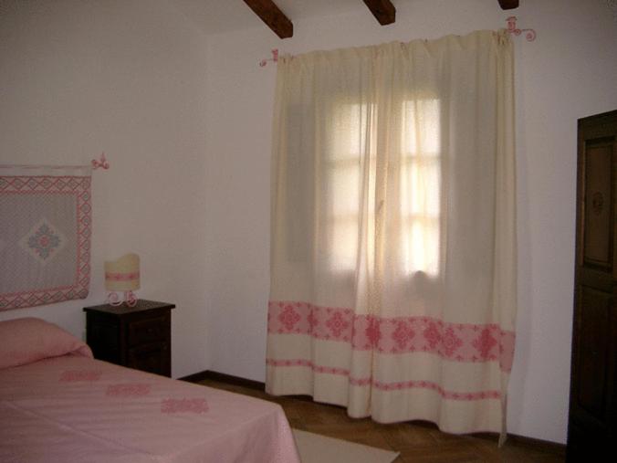 Postel nebo postele na pokoji v ubytování Agriturismo nuraghe Putzu Canu