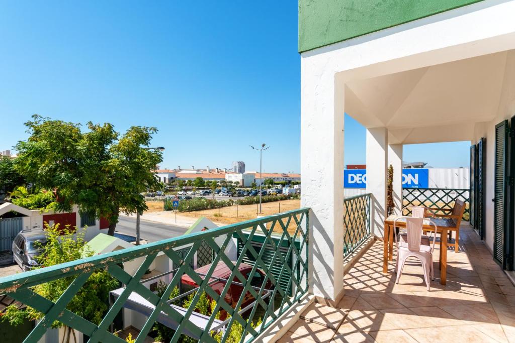 a balcony of a building with a table and chairs at Holiday house in elite residential area of Faro in Faro