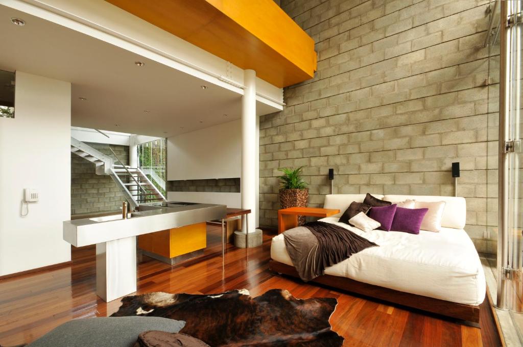 a bedroom with a bed and a sink at AcquaSanta Lofts Hotel in Cali