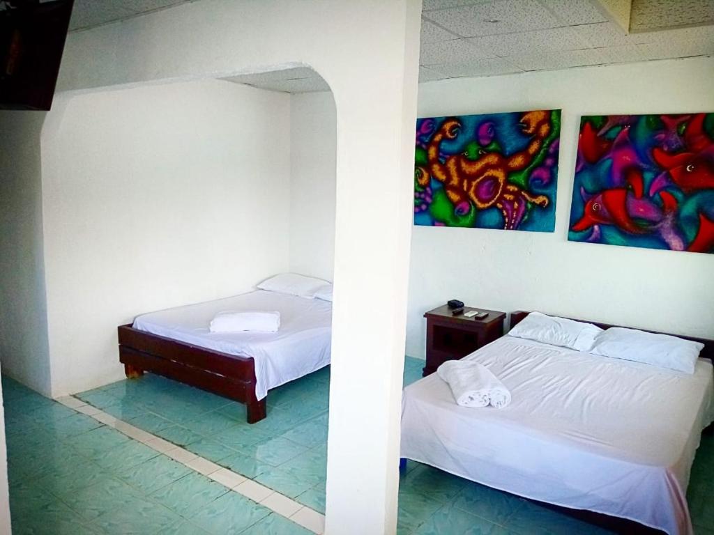 Ліжко або ліжка в номері Hotel Cocotal