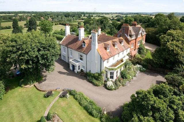 an aerial view of a large house in a field at Wartling Place Country House in Wartling