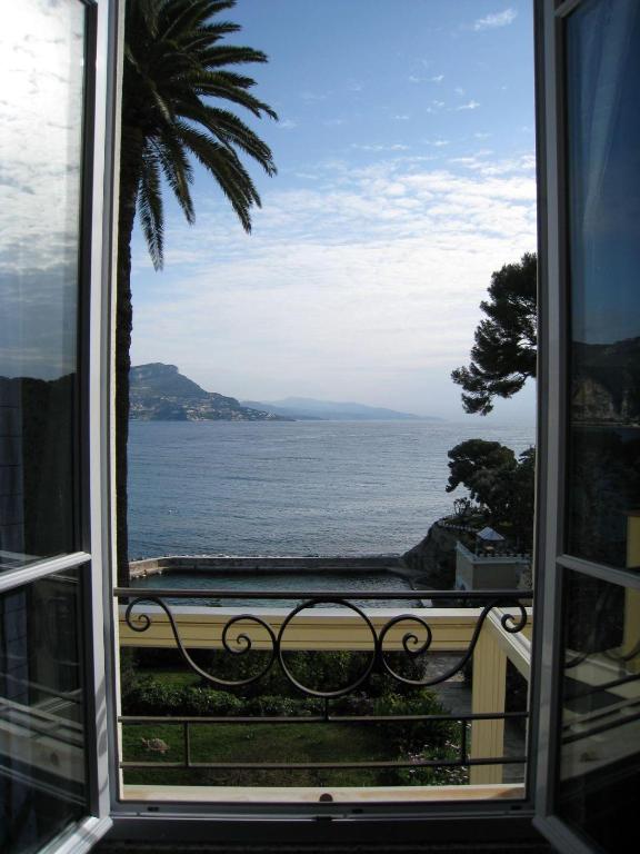 a view of the ocean from a window at Hôtel de Charme Brise Marine in Saint-Jean-Cap-Ferrat