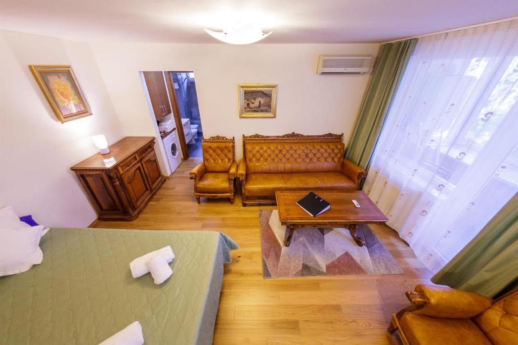 a living room with a bed and a couch at Apartament Family Rivulus 8 in Baia Mare