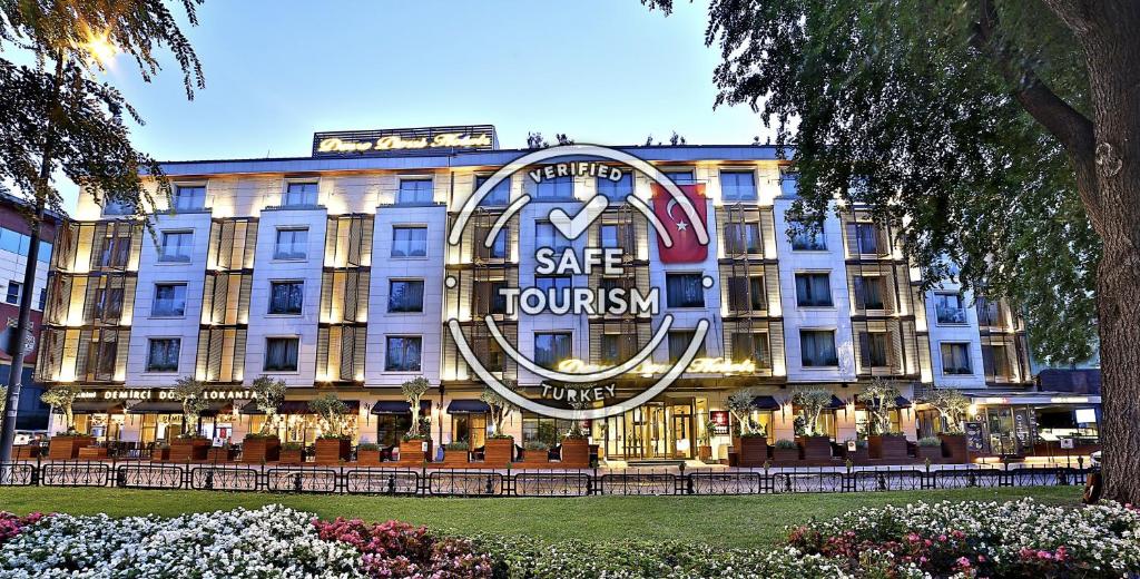 
a large building with a clock on the front of it at Dosso Dossi Hotels & Spa Downtown in Istanbul
