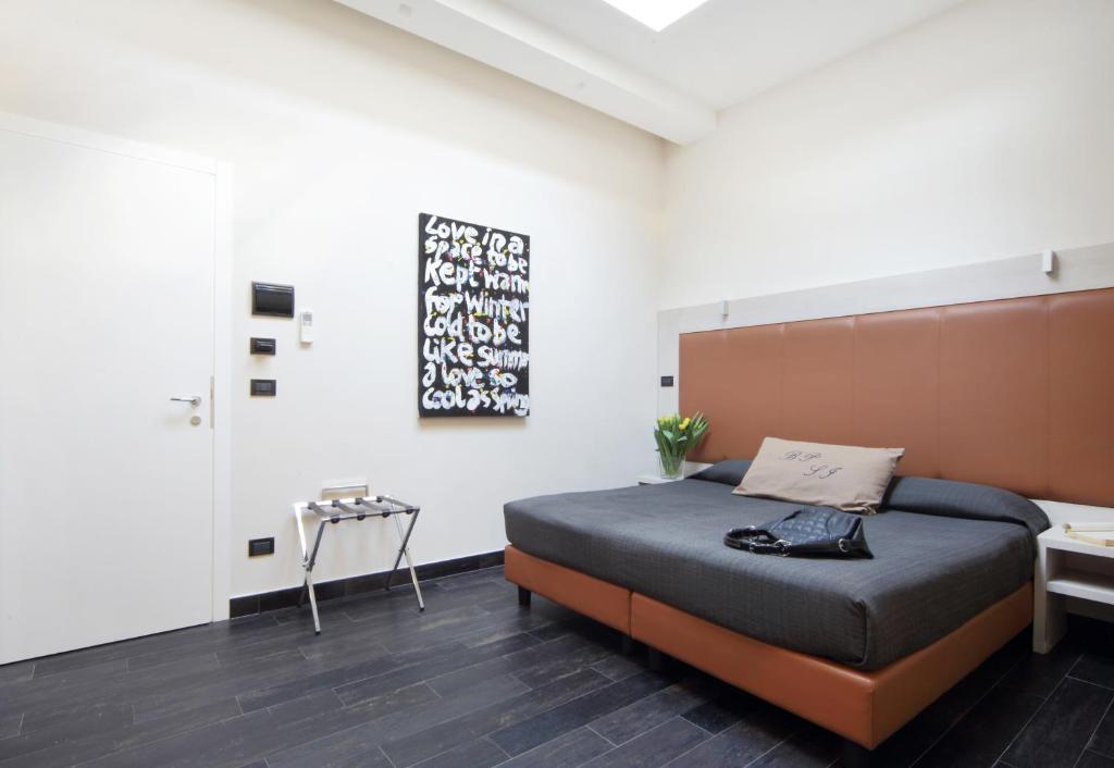 Posteľ alebo postele v izbe v ubytovaní Borgo Pio Suites Inn