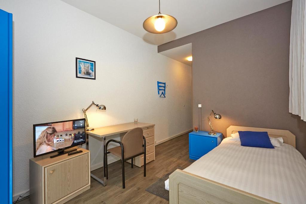 Postel nebo postele na pokoji v ubytování Les Chambres du CTN