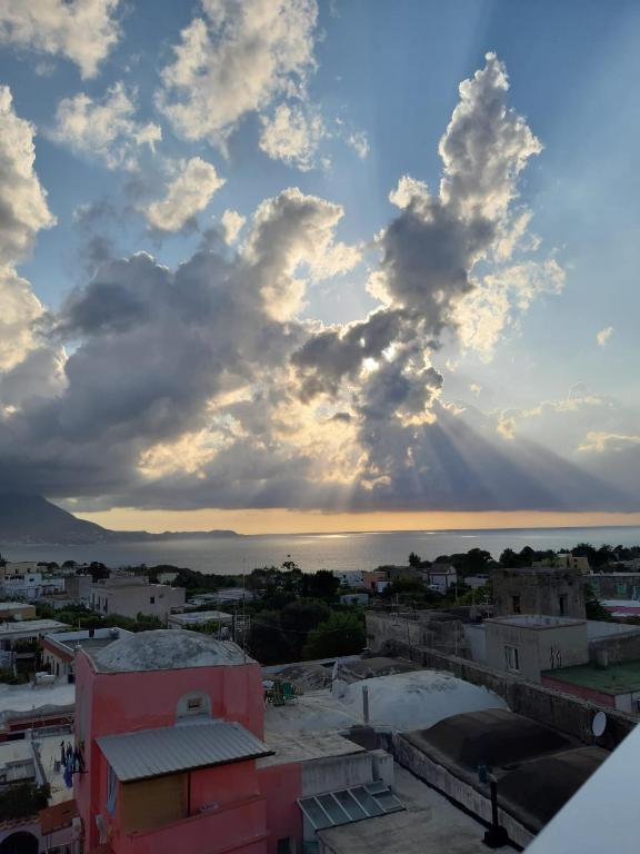 a view of the city with a cloudy sky at Le Volte Procida Home in Procida