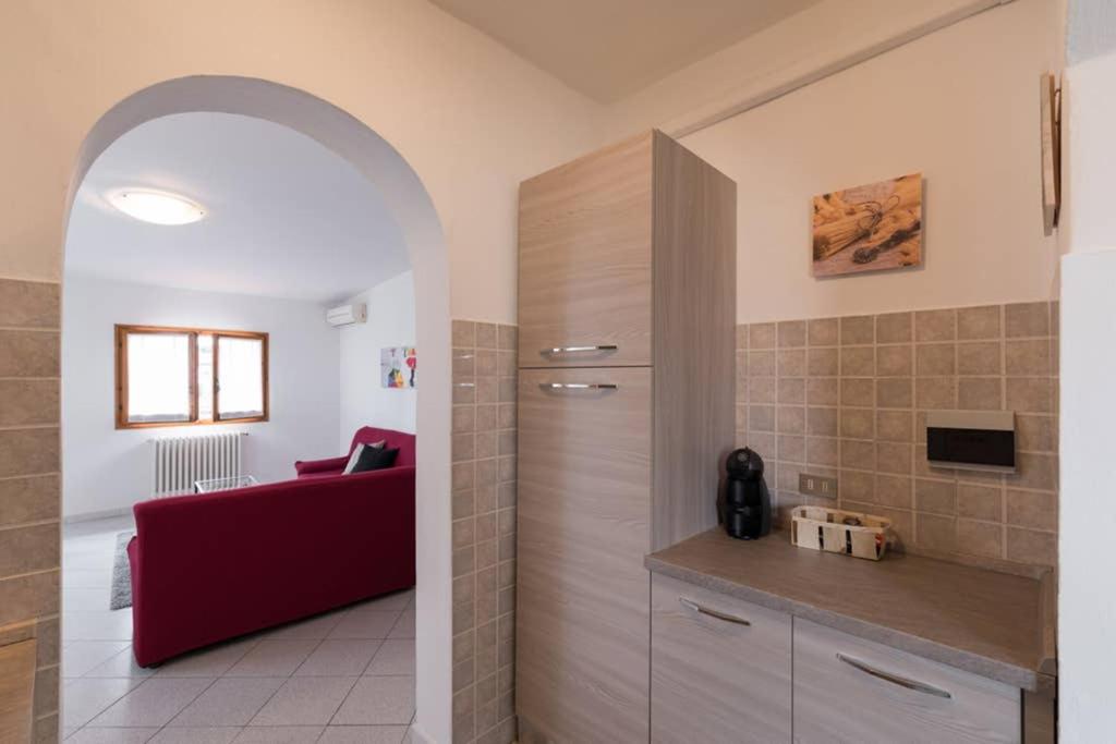salon z czerwoną kanapą w pokoju w obiekcie La Casa di Lucia - Firenze we Florencji