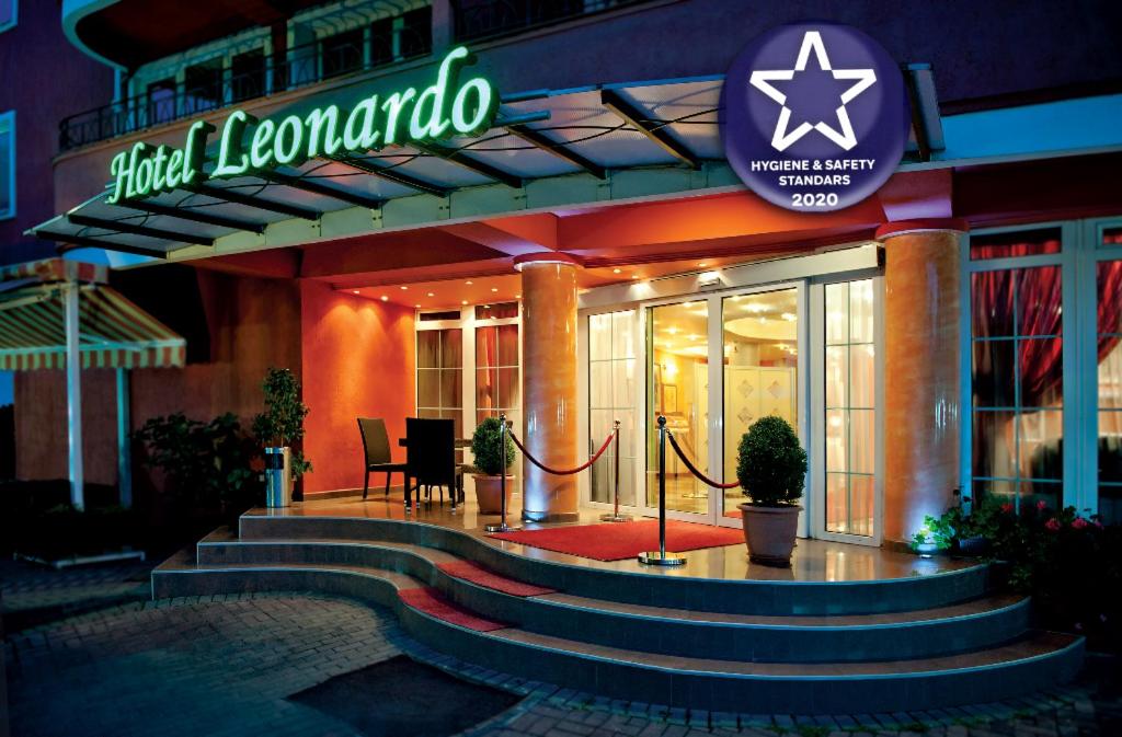 a building with stairs in front of a building with a sign at Leonardo Hotel in Skopje