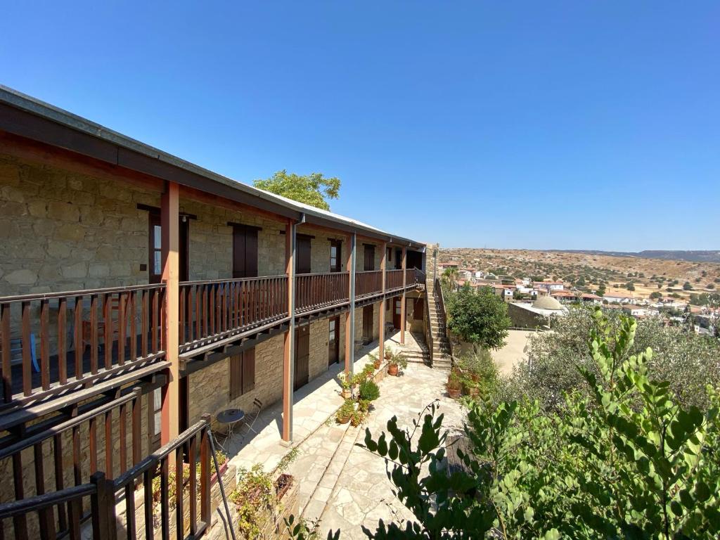 a building with a balcony with a view at Eveleos Country House in Tochni