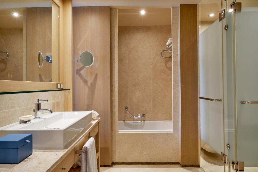 a bathroom with a sink and a shower at Daios Cove in Agios Nikolaos