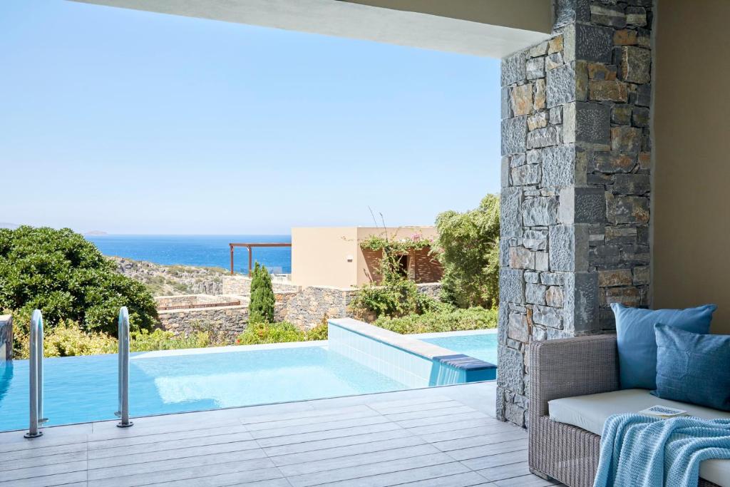 a view of a swimming pool from a villa at Daios Cove in Agios Nikolaos