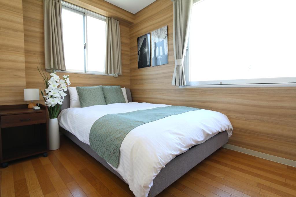 a bedroom with a large bed and a window at NM61 Liz Osaka Castle in Osaka