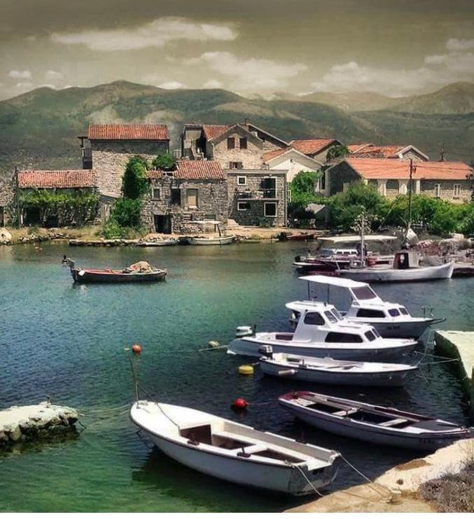 a group of boats are docked in a harbor at Apartment Dream Summer 2 -Premium Beach Apartament for 4 in Tivat