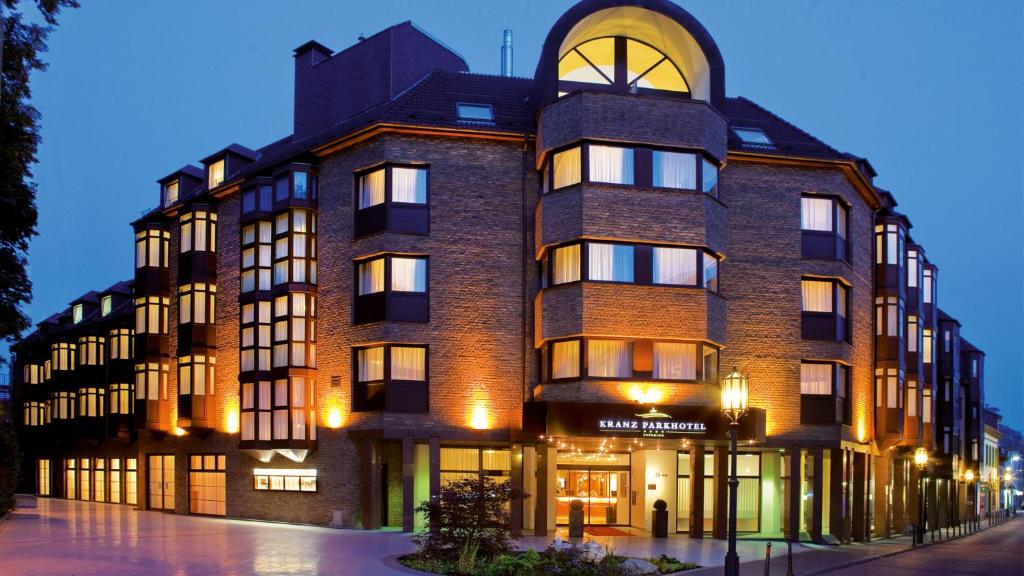 a large brick building on a street at night at Kranz Parkhotel in Siegburg