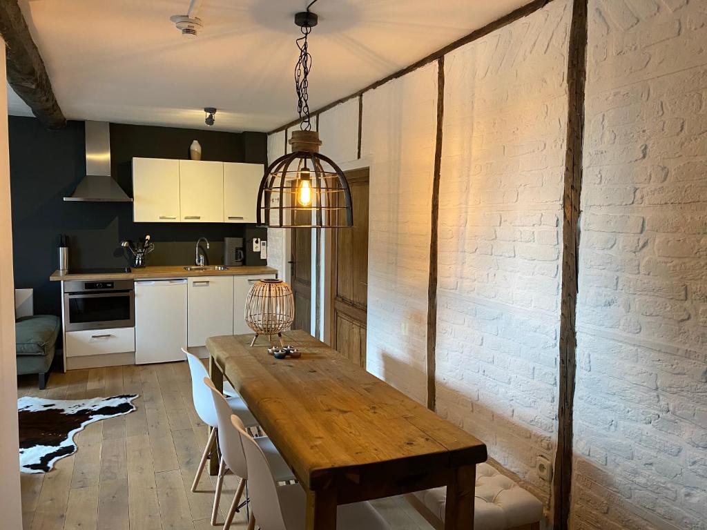 a kitchen with a wooden table in a room at Authentic Stays - 6p-apartment in Eijsden