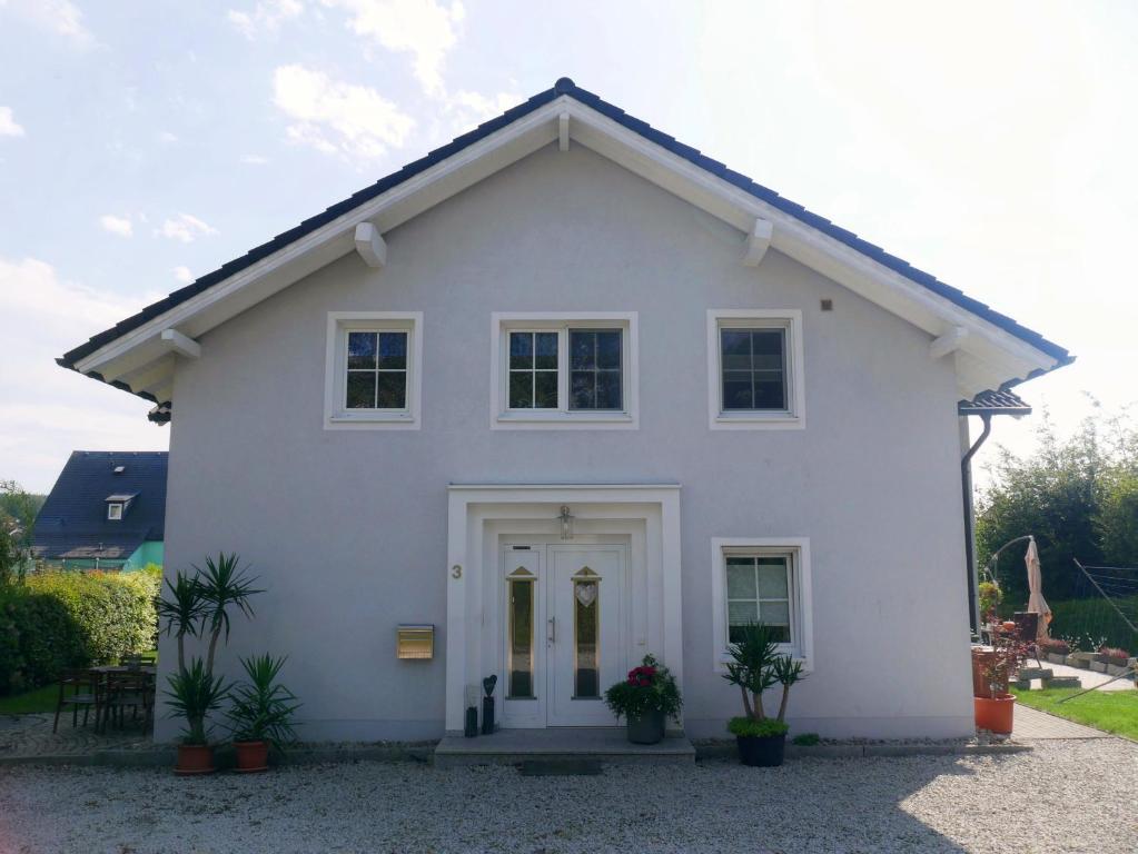 a white house with plants in front of it at Haus Alexandra in Schwarzenbach an der Saale