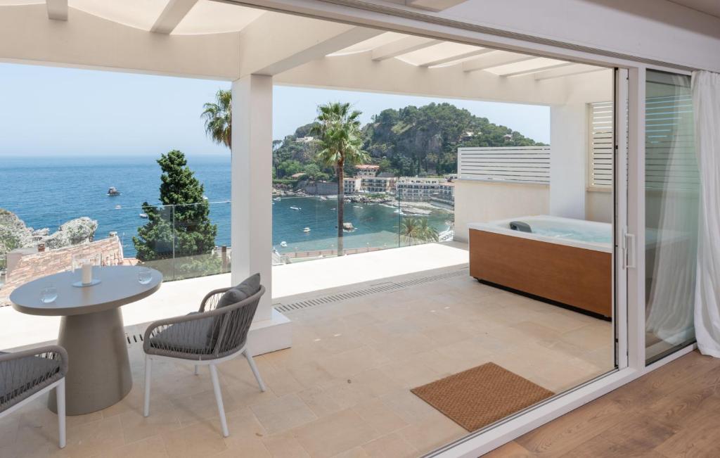 a living room with a view of the ocean at Iancu Charme Apartments in Taormina