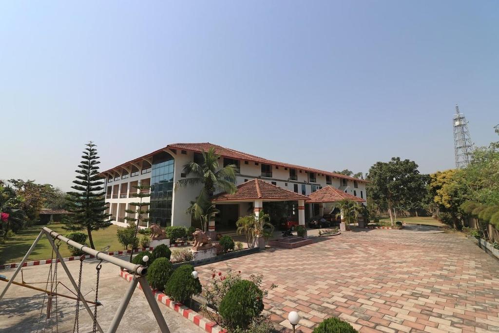 a large building with a brick driveway in front of it at King's Queen Crown Mandarmoni in Mandarmoni