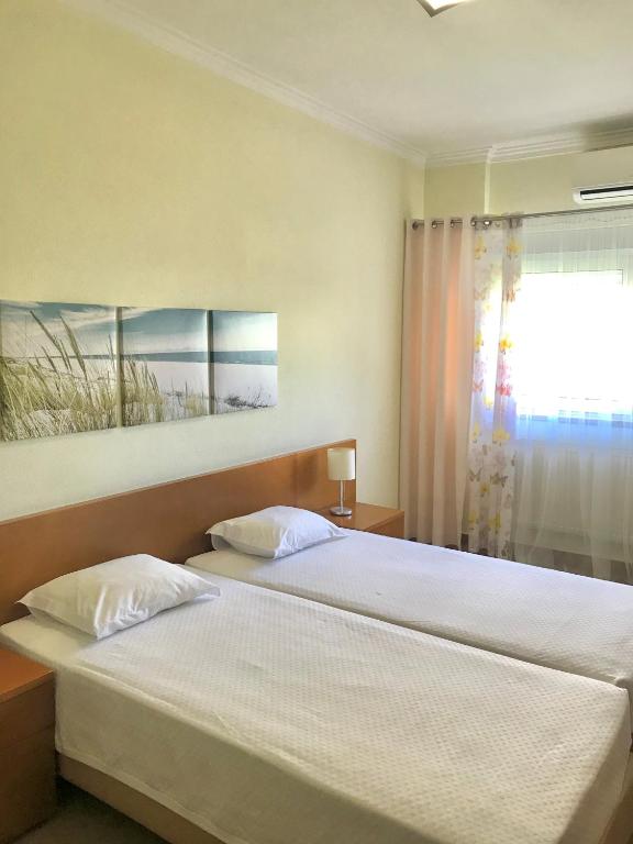 a bedroom with two beds and a window at ABLA Guest House in Carcavelos
