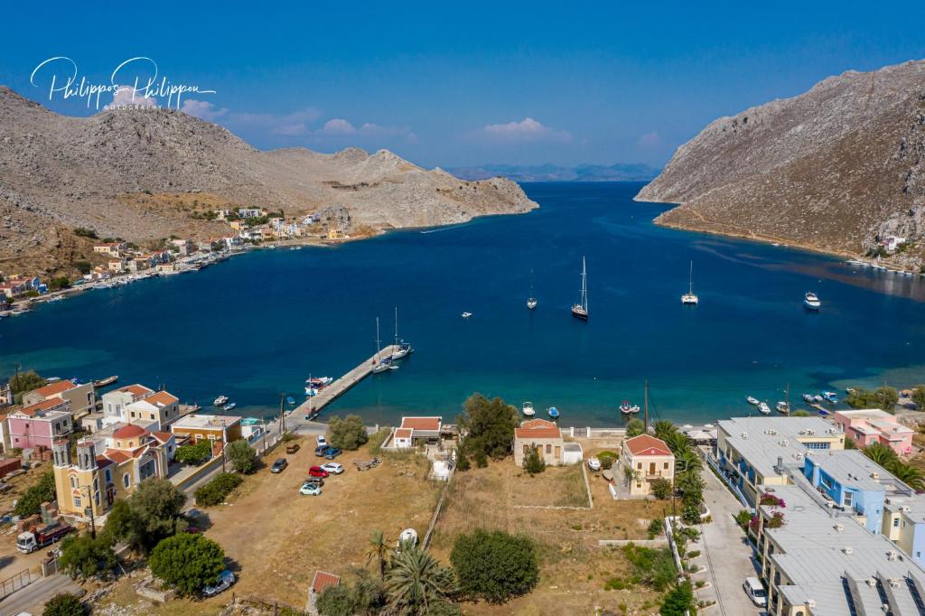 an aerial view of a town next to a body of water at Pedi Beach Hotel in Symi