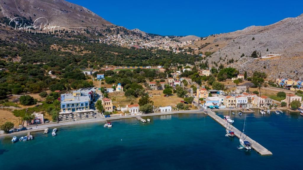 an aerial view of a small town on the water at Pedi Beach Hotel in Symi