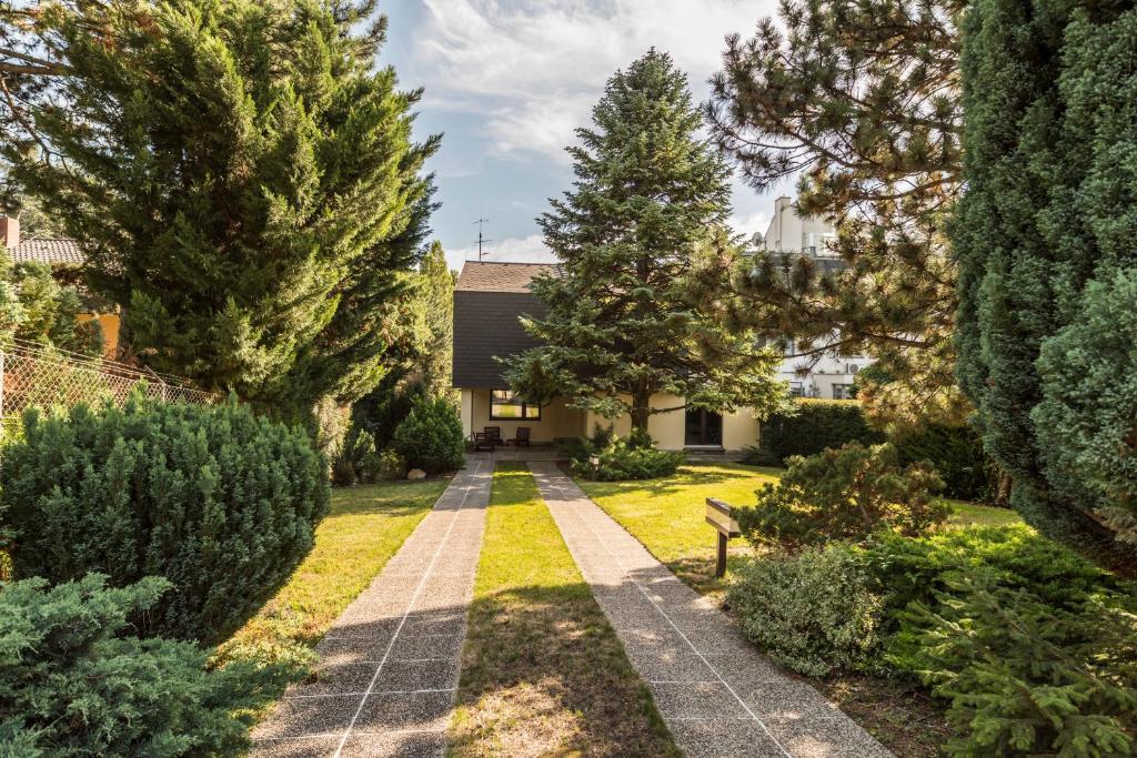 a garden with trees and a house at Yes, it is RETRO - Big Villa with Indoor Pool in Vienna