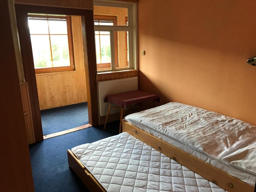 Postel nebo postele na pokoji v ubytování Penzion Bouda Tonička