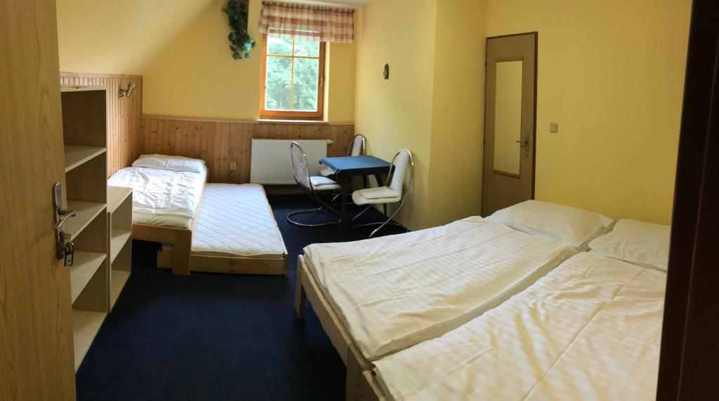 Postel nebo postele na pokoji v ubytování Penzion Bouda Tonička