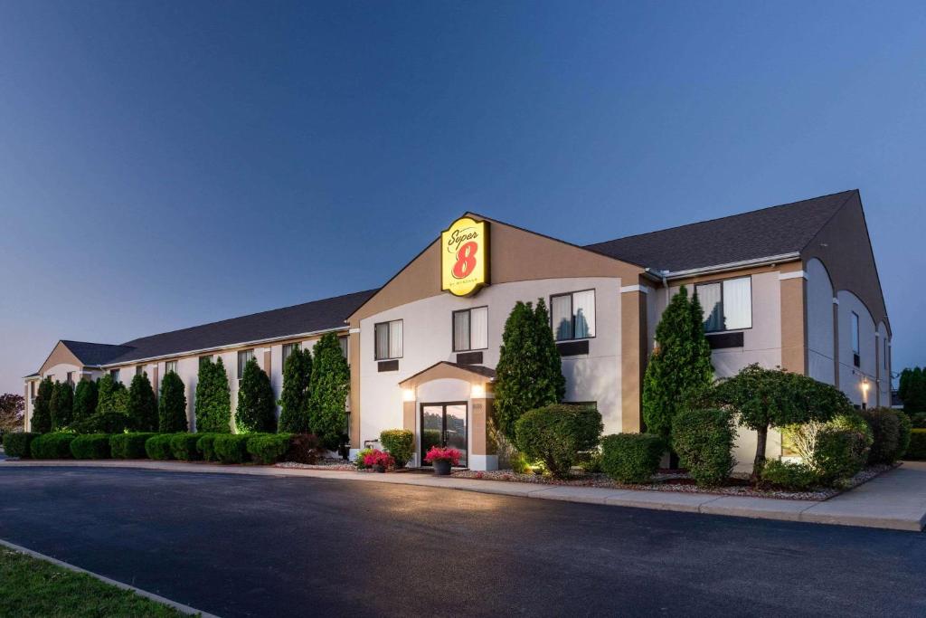 a hotel with a sign on the side of a road at Super 8 by Wyndham Goshen in Goshen