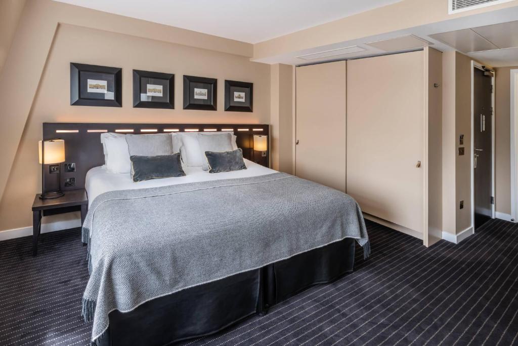 a hotel room with a large bed with two pillows at The Resident Victoria in London