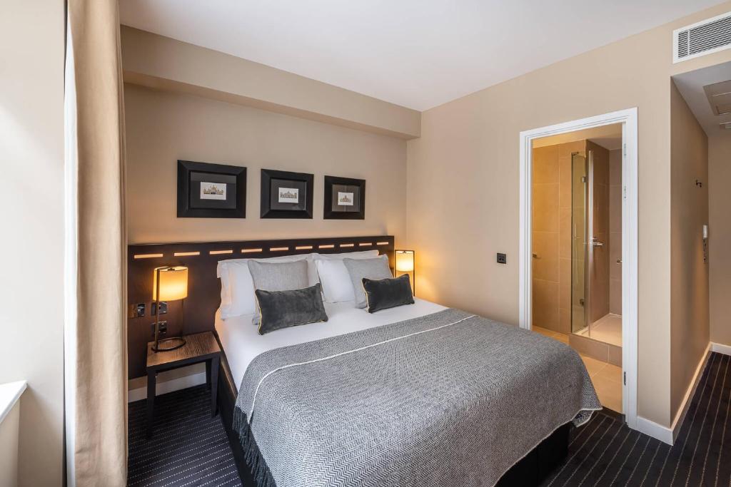 a hotel room with a large bed with two pillows at The Resident Victoria in London