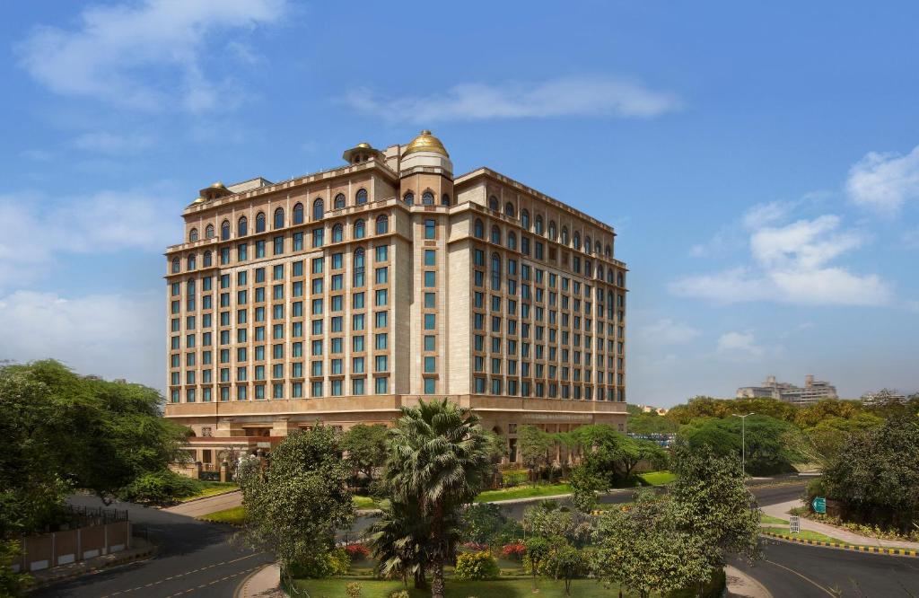 a tall building with a clock on the top of it at The Leela Palace New Delhi in New Delhi