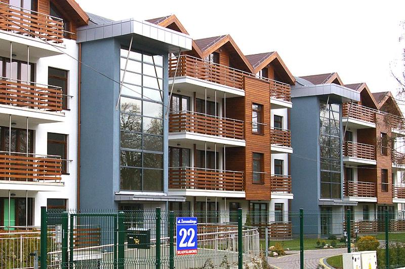 a large apartment building with a sign in front of it at Apartament Kasztanowy in Władysławowo