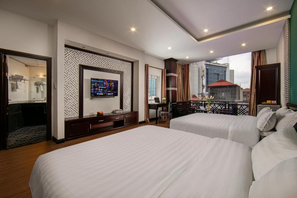 Postel nebo postele na pokoji v ubytování ĐỨC TRỌNG HOTEL
