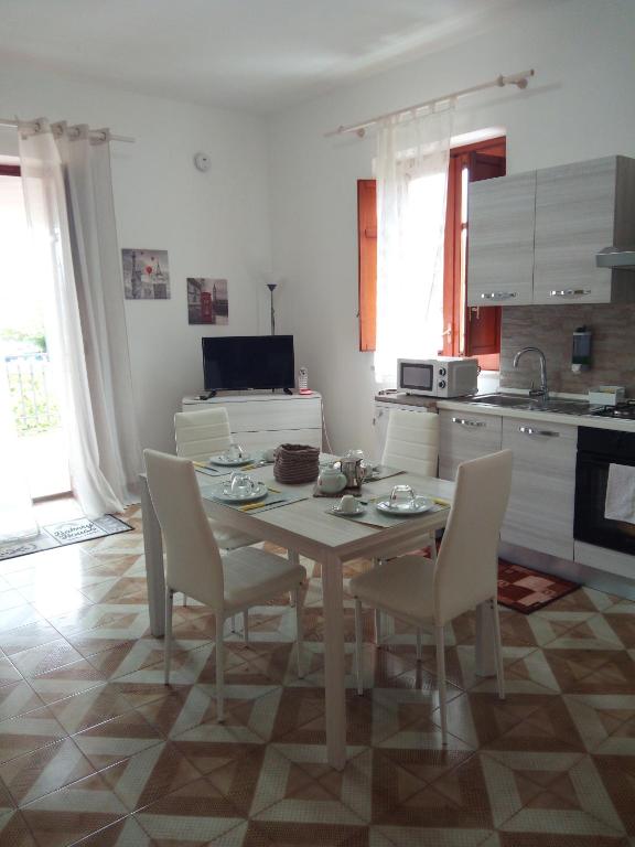 a kitchen with a table and chairs in a room at Appartamento a Mondello in Mondello