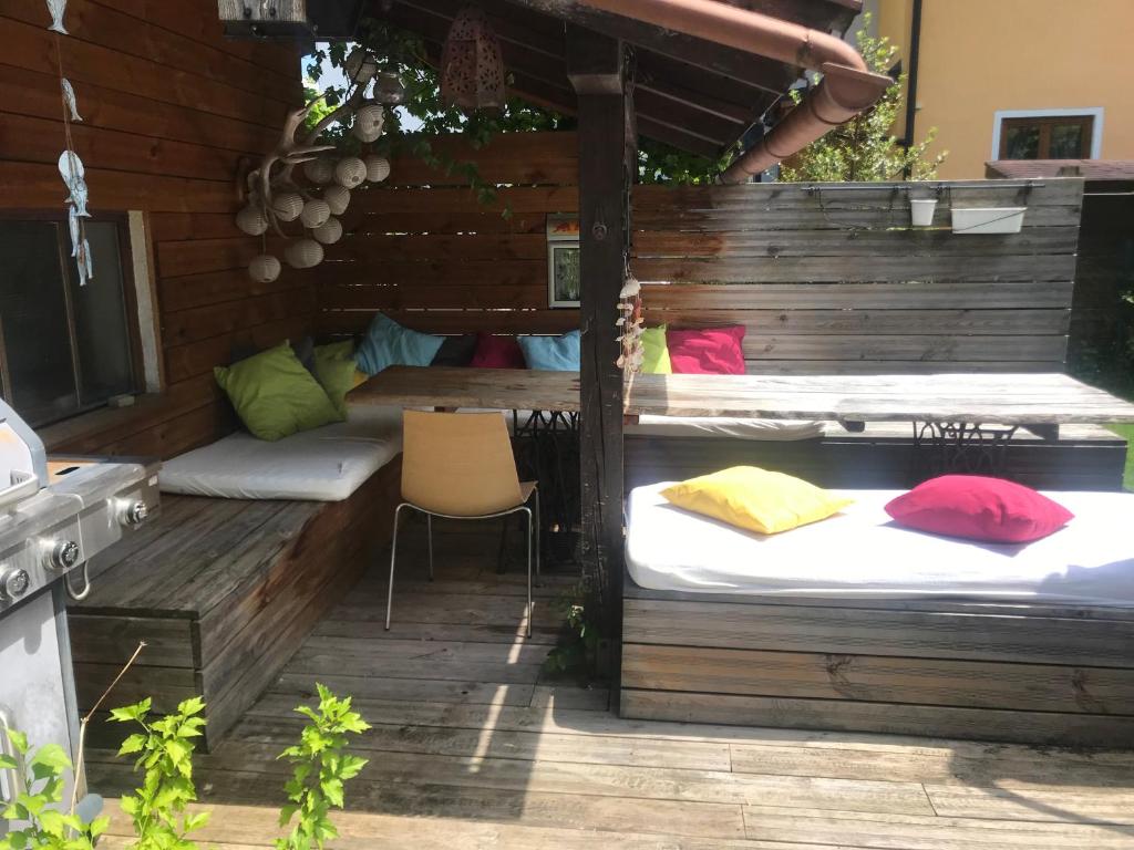 a patio with two beds and a table and a chair at Villa Nussbaum in Golling an der Salzach