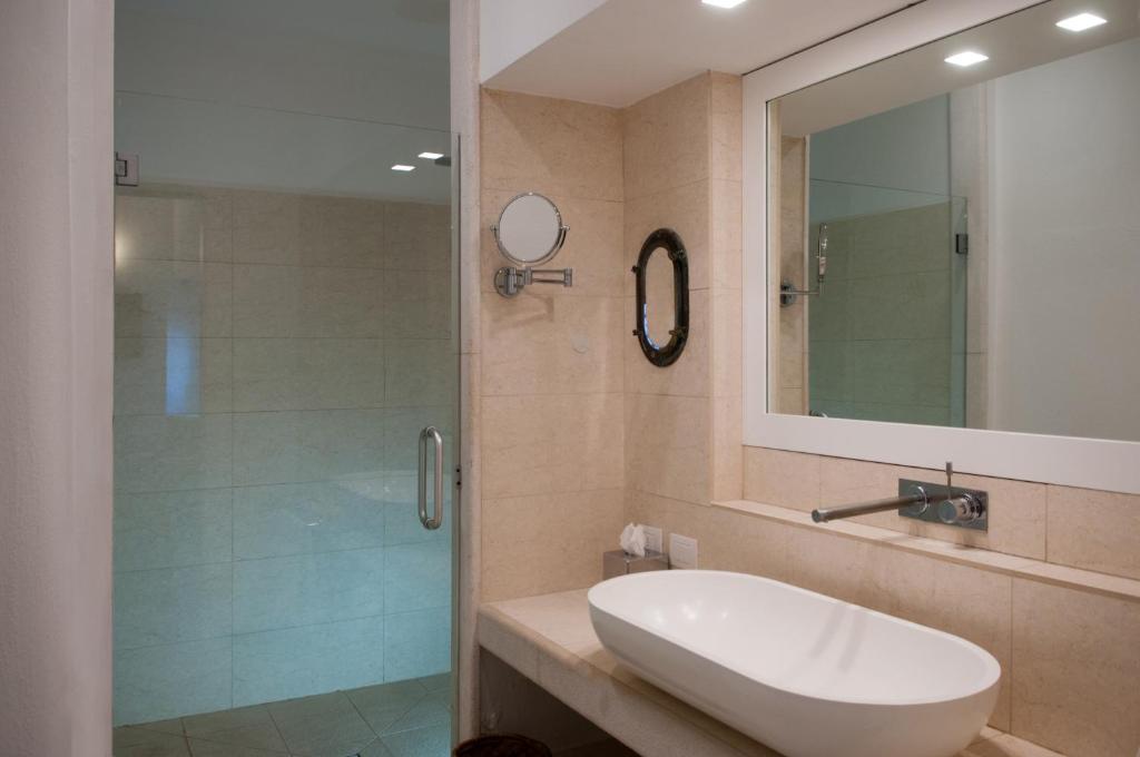 a bathroom with a sink and a shower at La Peschiera in Monopoli