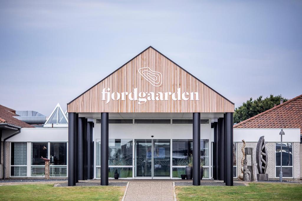 
a building with a sign on the front of it at Fjordgaarden - Kurbad - Hotel - Konference in Ringkøbing
