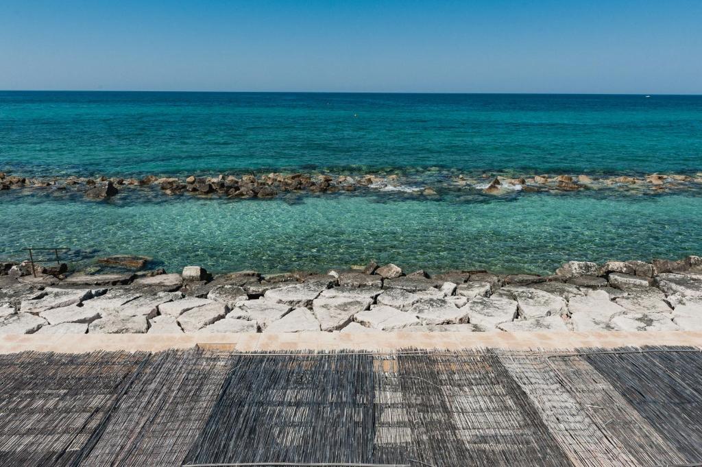 a view of the ocean from a pier at La Peschiera in Monopoli